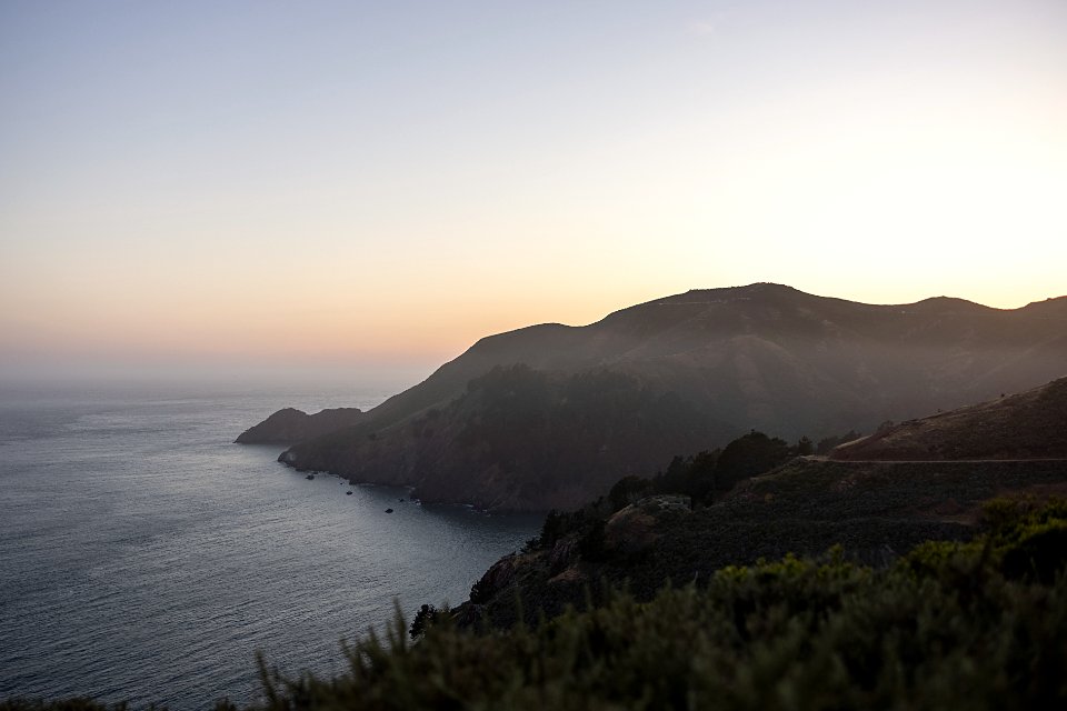 A headland dissolving into sea mist