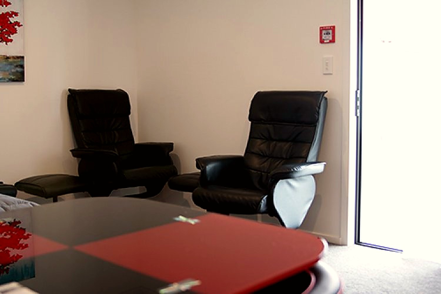 Two recliner chairs and a small round table